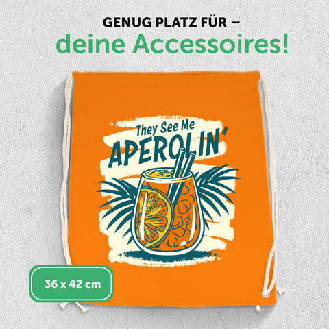 Farbiger Turnbeutel mit DTF-Druck - They see me Aperolin