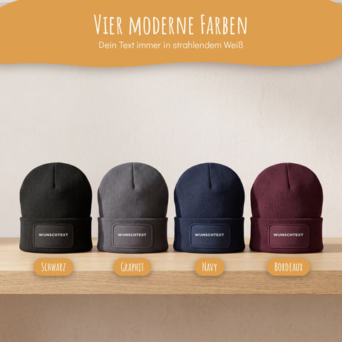 Vier personalisierte Mützen in Schwarz, Graphit, Navy und Bordeaux mit weißem Wunschtext